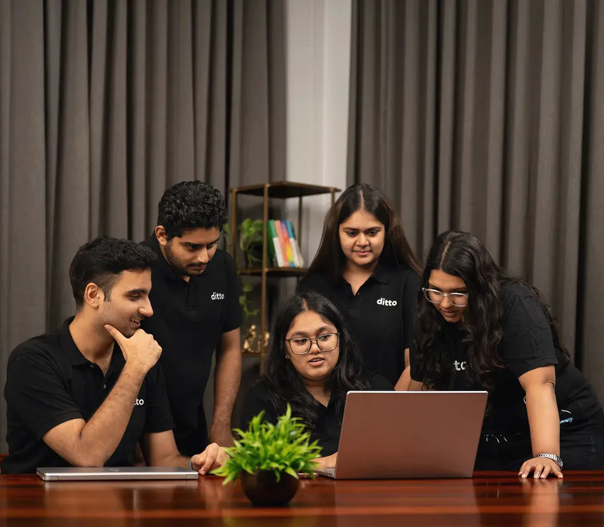 Ditto team discussing insurance strategy in the office